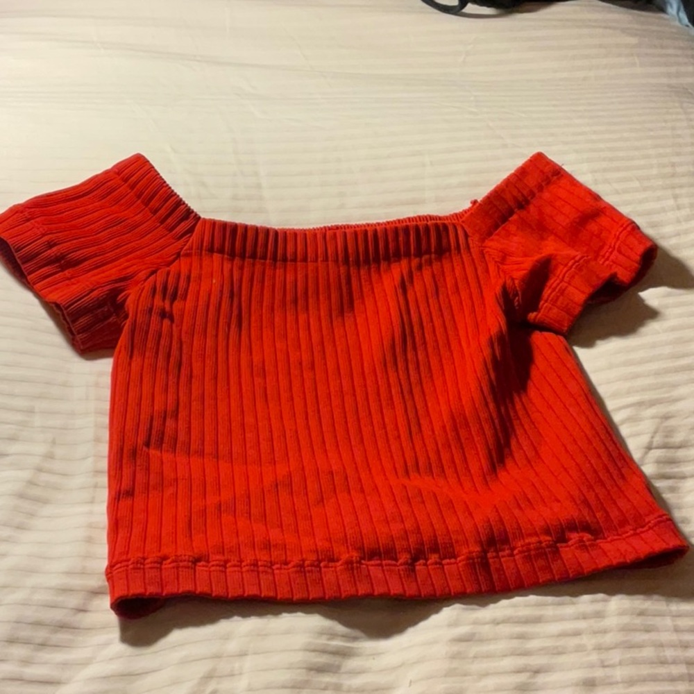 This tops runs small. It can be worn of the shoulder or just like a regular top.